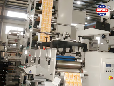 Kingsun stack type flexo printing machine processing label rolls with precision, showing the rollers and printing units in a real factory environment.