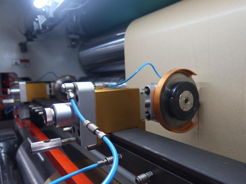 Detailed side view of a Kingsun pneumatic circular slitting blade holder installed on a precision guide rail for consistent paper and film converting.